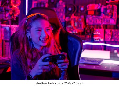 Gamer using joystick controller for virtual tournament plays online video game with computer neon lights dark room, woman wear gaming headphones playing live stream esports games console at home