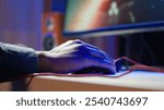 Gamer using keyboard and wired mouse to play videogames on desktop PC, close up shot. Man playing online game in front of monitor with computer peripherals at desk in apartment, camera A