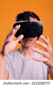 Gamer Wearing Vr Headset Playing Virtual Reality Games, Exploring Metaverse Close View, Focus On Hands. Person In Ar Goggles Enjoying Simulation Experience, Cyberspace Entertainment