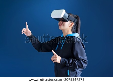 Gamer woman with handsup touching icon in the air and wearing VR glasses or virtual reality glasses ,Virtual reality with esport concept