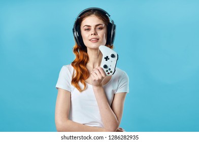 Gamer Woman In Headphones And With A Joystick In His Hand                       