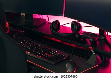 Gamer Work Space Concept, Gaming Gear, Mouse, Keyboard, Joystick, Headset, Headphone And Mouse Pad On Black Table Background.