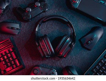 Gamer Work Space Concept, Top View A Gaming Gear, Mouse, Keyboard, Joystick, Headset With Rgb Color On Black Table Background.