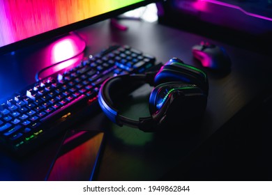 Gamer Work Space Concept, Top View A Gaming Gear, Mouse, Keyboard, Joystick, And Headset With Rgb Color On Black Table Background.