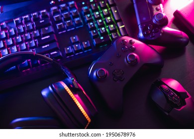 Gamer Work Space Concept, Top View A Gaming Gear, Mouse, Keyboard, Joystick, Headset With Rgb Color On Black Table Background.