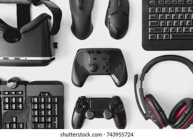 Gamer Workspace Concept, Top View A Gaming Gear, Mouse, Keyboard, Joystick, Headset, VR Headset On White Table Background.