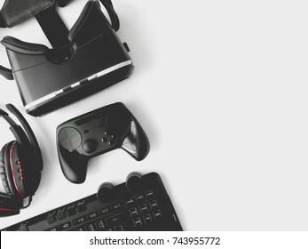 Gamer Workspace Concept, Top View A Gaming Gear, Keyboard, Joystick, Headset, VR Headset On White Table Background With Copy Space.