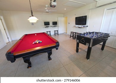 A Games Room With Pool Table And Foosball