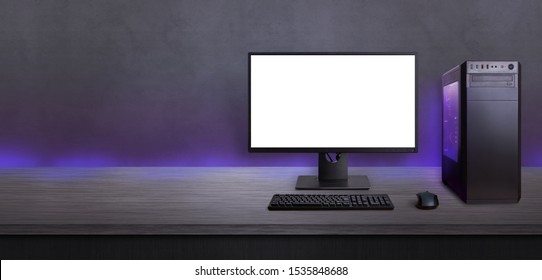 Gaming Computer On Desk With Isolated Screen For Mockup. Free Space Beside For Promo Text. Modern Computer With RGB Light.