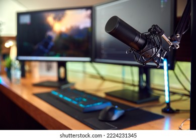 Gaming Computer Setup On Desk At Home With Microphone And Multiple Monitors