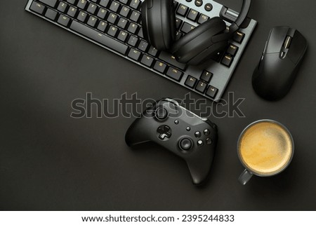 Gaming concept on black background with computer keyboard and joystick
