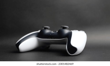 Gaming console controller on black background closeup modern