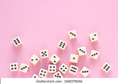 Gaming dice with copy space on pink background. Concept for games, game board, presentation, banners or web. Top view. Close-up.