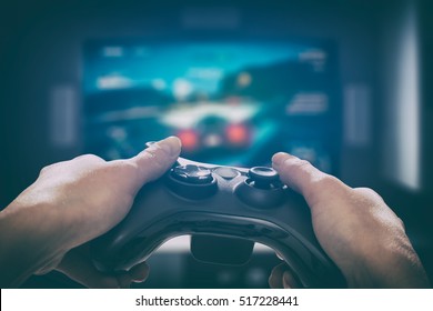 gaming game play tv fun gamer gamepad guy controller video console playing player holding hobby playful enjoyment view concept - stock image - Shutterstock ID 517228441