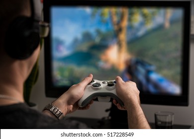 gaming game play tv fun gamer gamepad guy controller video console playing player holding hobby playful enjoyment view face concept - stock image