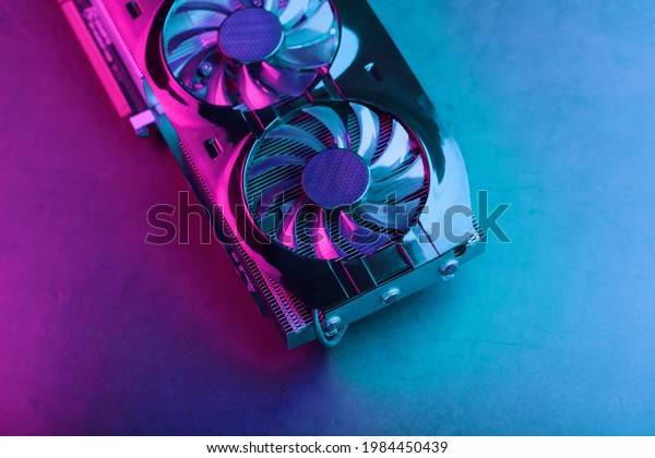 Gaming graphics card with neon magenta-cyan\
illumination and high-speed\
fans.