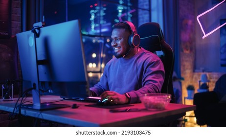 Gaming at Home: Portrait of a Happy African American Gamer Winning a Round in Online Video Game on Personal Computer. Professional Stylish Male Player Enjoying Online Multiplayer PvP Tournament.