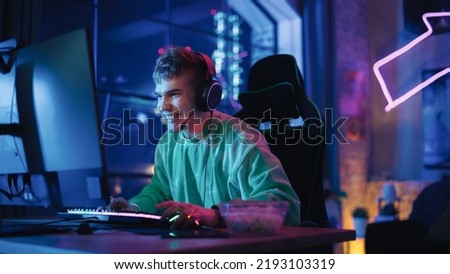 Gaming at Home: Portrait of a Happy Gamer Winning a Round in Online Video Game on Personal Computer. Professional Stylish Male Player Enjoying Online Multiplayer PvP Championship.