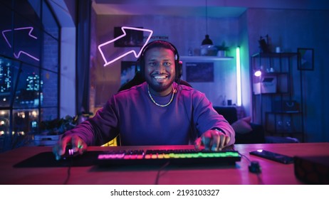 Gaming at Home: Satisfied African American Gamer Winning a Round in Online Video Game on Computer. Stylish Young Black Man Playing PvP Multiplayer Tournament. POV from Screen Perspective.