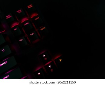 Gaming Keyboard On A Black Mousepad Illuminating With Different Colors