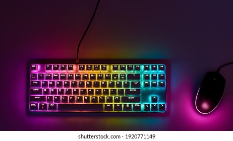 Gaming keyboard with RGB light. White mechanical keyboard and mouse with backlight. Colorful keyboard and mouse with RGB backlight. Gamer's Workspace