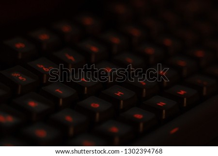 Gaming led keyboard. Shallow depth of field. Glowing red keyboard. 