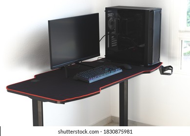 Gaming PC In A Gaming Desk. Shown In The Picture Are Three Gaming Monitors Standing On The Table.