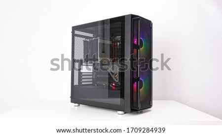Gaming PC with RGB LED lights and big fans on the front. Computer assembled with hardware components