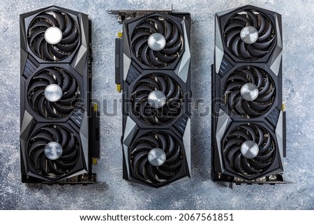 Gaming video card on a concrete background for video games and cryptocurrency mining. Computer parts. GPU card.