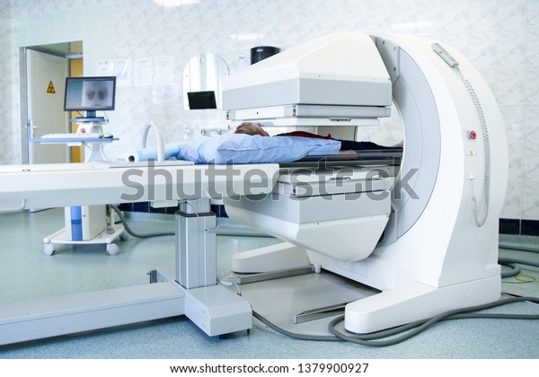 Gamma camera in the\
parlor of the clinic of nuclear medicine. Medical equipment in the\
hospital. Body examination equipment. The patient undergoes a\
medical examination.