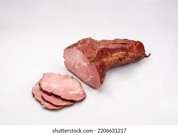 Gammon, smoked ham - in one piece and sliced, isolated on a white background. Polish cold cuts, a packshot photo.