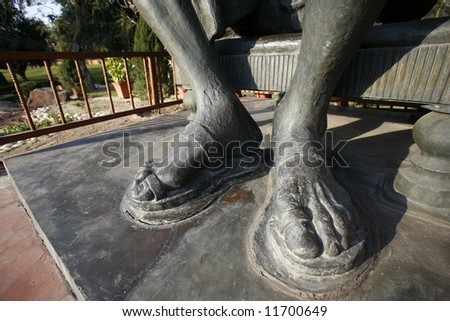 gandhi's feet statue at rajghat memorial in new delhi, india