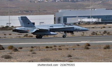 Gando Airport Gran Canaria Spain OCTOBER, 21, 2021 Full side view of a warplane landing in a desert airport with hangars in the background. McDonnell Douglas F-18 Hornet of Spanish Air Force