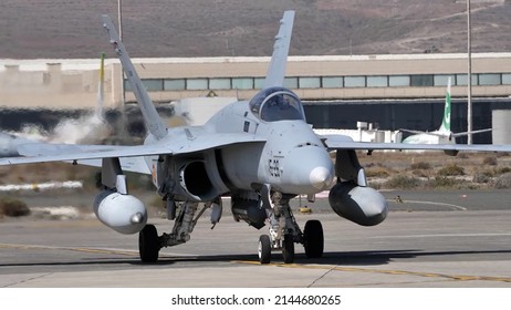 Gando Airport Gran Canaria Spain OCTOBER, 21, 2021 Powerful NATO fighter jet frontal view with running engines and two fuel tanks under the wings. McDonnell Douglas F-18 Hornet of Spanish Air Force