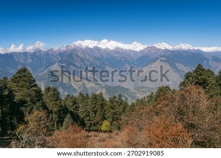 Ganesh Himal mountain range in Nepal - distant hills and snowy peaks with forest in the foreground
