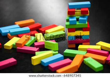 Gang game on a black table, colored cubes