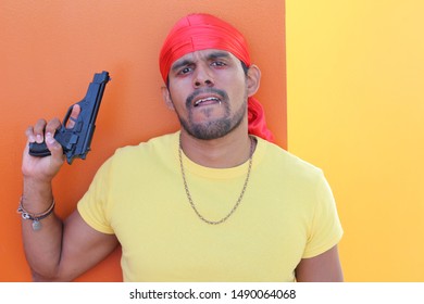 Gang Member Holding A Gun