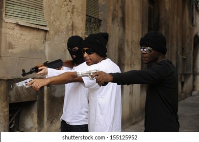 Gang members or guerrilla with gun and rifle on the street 