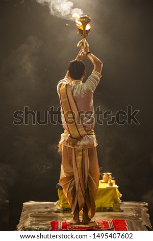Ganga aarti performed in the evening by an unidentified priest at the Dashashwamedh Ghat. Ganga Aarti is performed at the three holy cities of Haridwar, Rishikesh, and Varanasi, India.