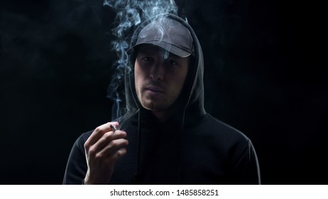 Gangster In Black Holding Cigarette And Looking Camera, Banditry Racketeering