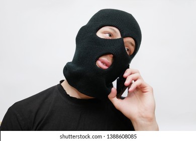 Gangster Man In Black Mask Talking On The Phone. Receiving Orders. Crime Informing. Tired Robber Dialogue Over The Phone.