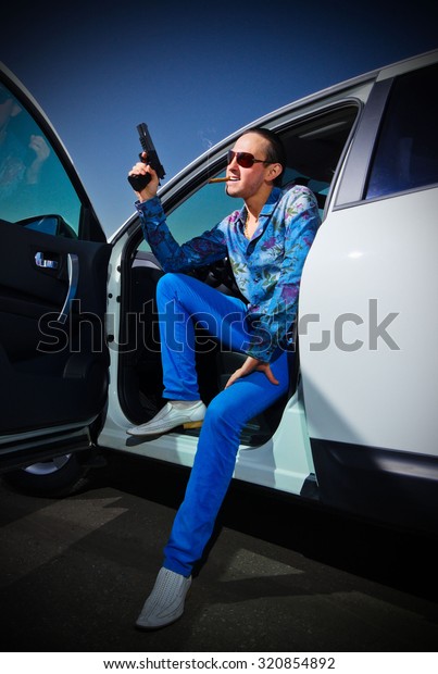 Gangster man with cigar near\
the car