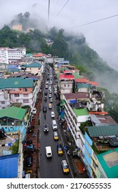 Gangtok, Sikkim - June 16 2022, Tourists Enjoy A Rope Way Cable Car Ride Over Gangtok City. Amazing Aerial City Scape Of Sikkim. Covered In Mist Or Fog. North East India Tourism,  Aerial Cityscape.