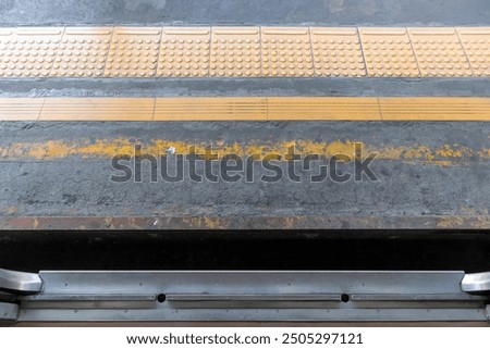 The gap between the carriage and the train platform at the station with yellow guiding block brick
