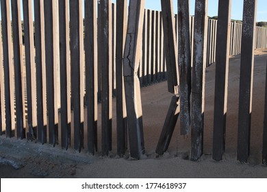 A Gap In A Concrete Fence. Breaking Free Concept Image.