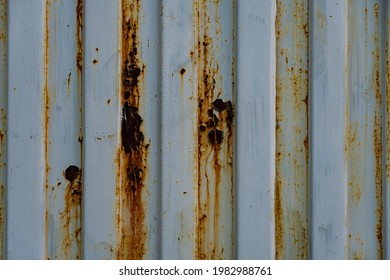 Garage Corrosion On A Rough Striped Metal Wall Or Floor, Scratches, Air Holes, Rusty House Fence, Holes, Dents, Pins.