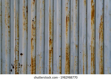 Garage Corrosion On A Rough Striped Metal Wall Or Floor, Scratches, Air Holes, Rusty House Fence, Holes, Dents, Pins.