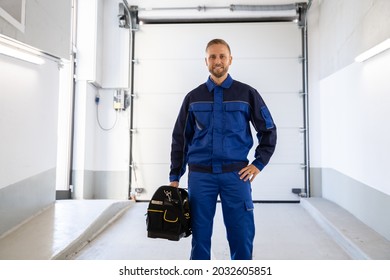 Garage Door Installation And Repair At Home. Contractor Man In House - Shutterstock ID 2032605851