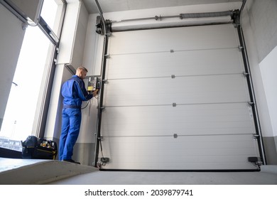 Garage Door Installation And Repair At Home. Contractor Man In House