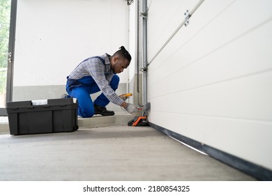 Garage Door Installation And Repair At Home. Contractor Man In House